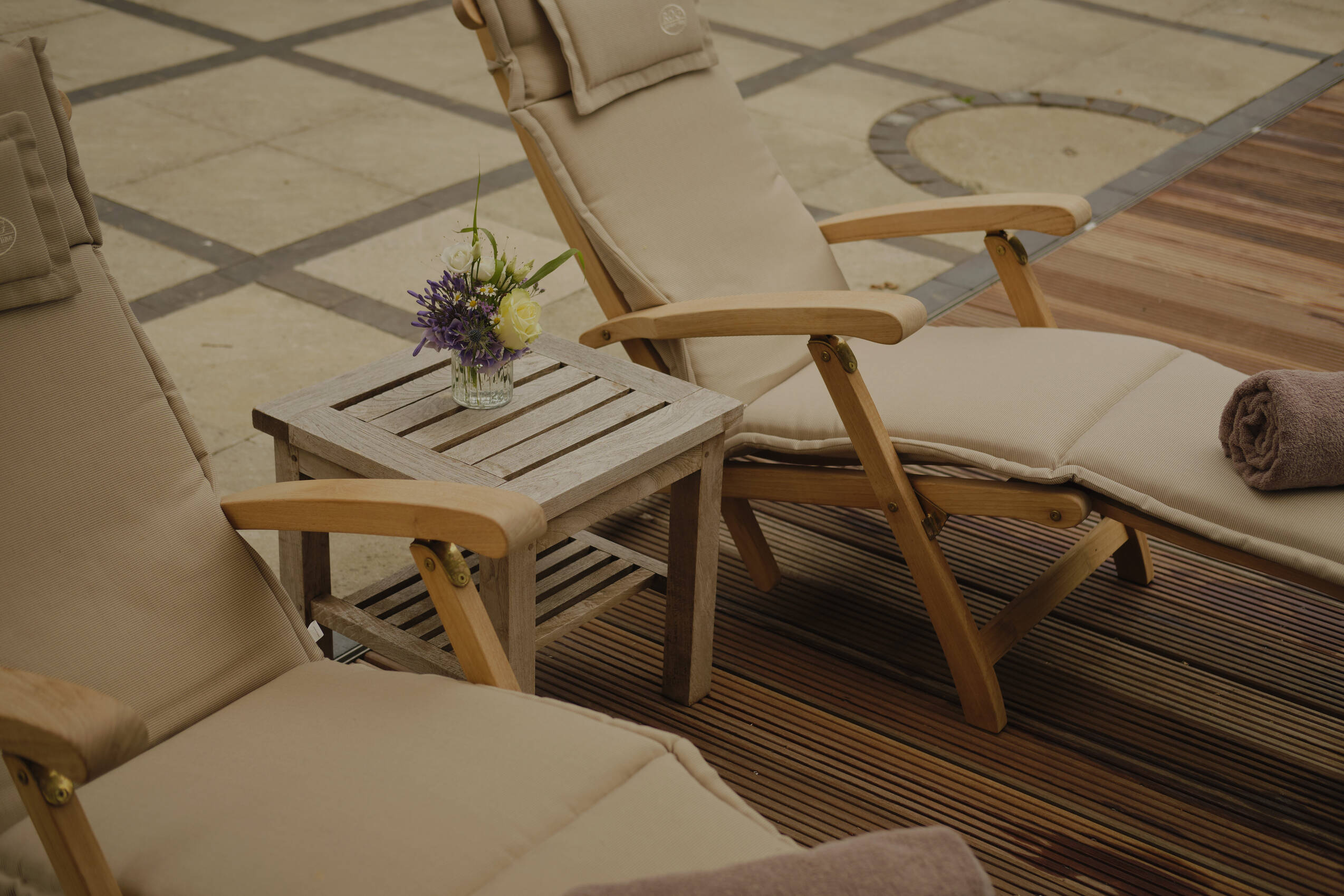 Zwei Liegestühle am Pool – sonnige Ruhe Oase und Erholung pur im exklusiven Wellnesshotel Mecklenburg Vorpommern.